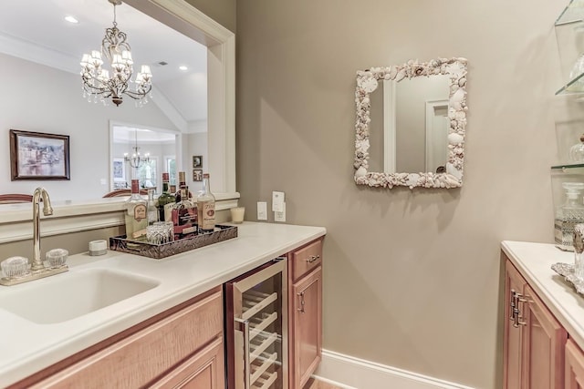 bar featuring sink, ornamental molding, hanging light fixtures, beverage cooler, and lofted ceiling