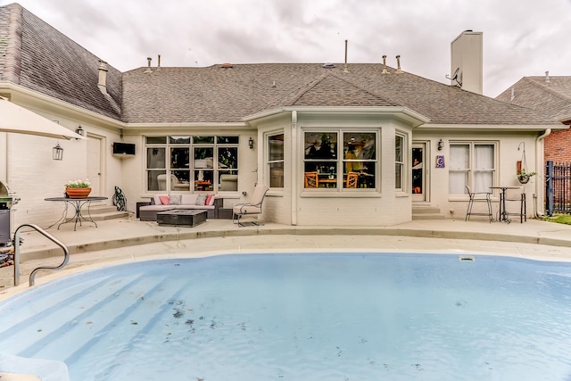 view of swimming pool with an outdoor living space and a patio area