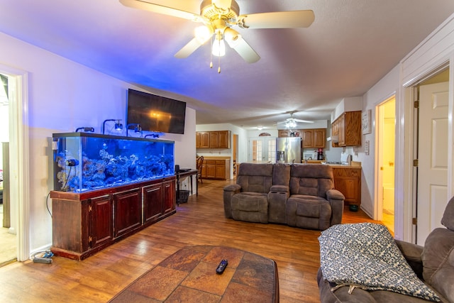 living room with hardwood / wood-style floors and ceiling fan