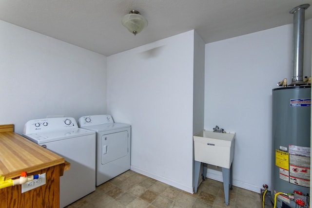 laundry area with water heater and washer and dryer