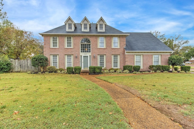 colonial inspired home with a front yard