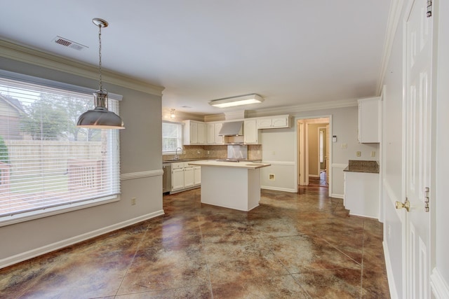 kitchen featuring dishwasher, a kitchen island, wall chimney exhaust hood, and ornamental molding