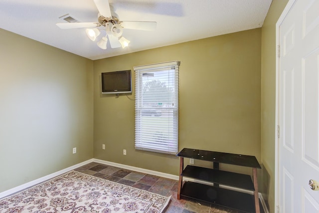 miscellaneous room with a textured ceiling and ceiling fan