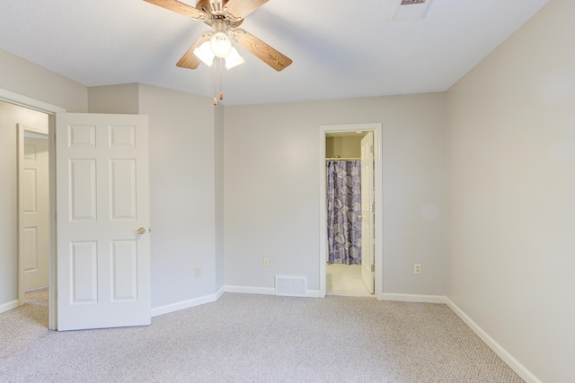 unfurnished bedroom with light colored carpet, ceiling fan, and connected bathroom