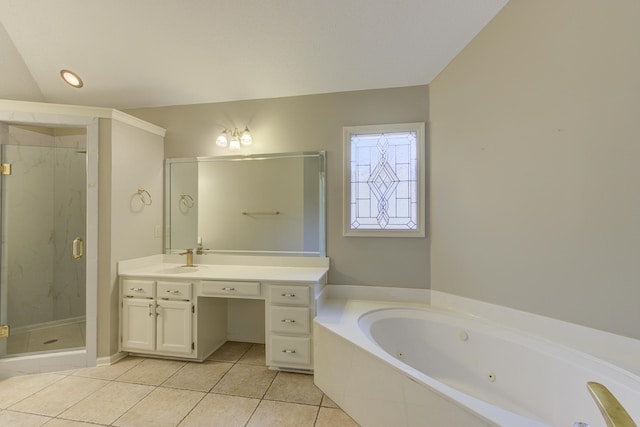 bathroom featuring tile patterned flooring, vanity, and shower with separate bathtub