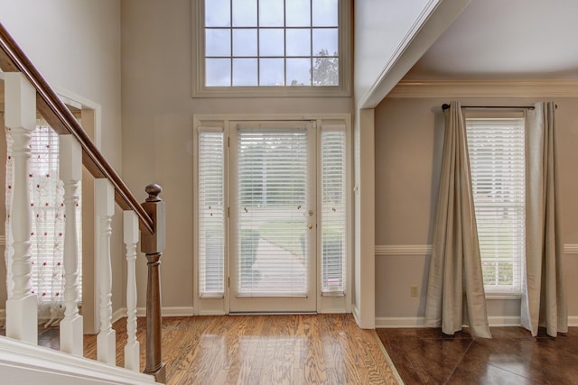 doorway to outside featuring ornamental molding, hardwood / wood-style flooring, and a healthy amount of sunlight