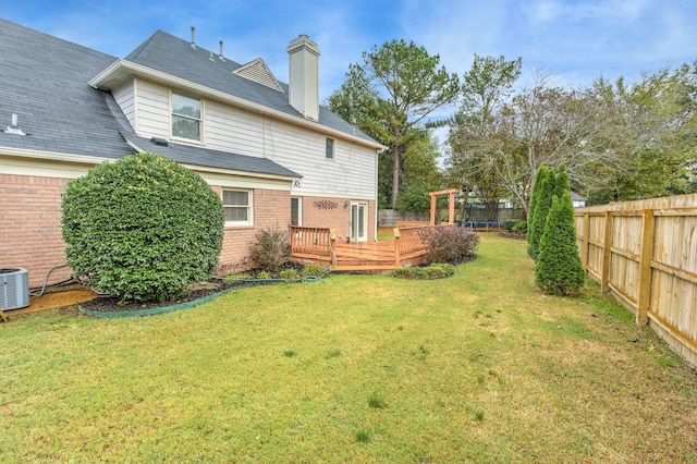 view of yard featuring a deck and central AC unit