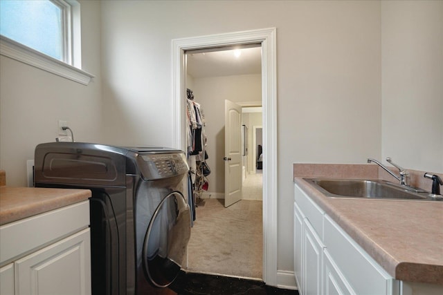 clothes washing area featuring cabinets, carpet floors, sink, and washer / clothes dryer