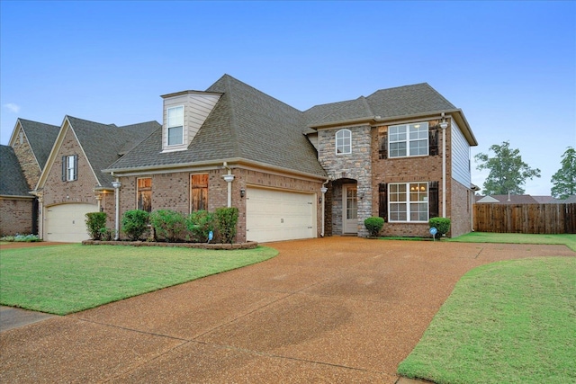 view of front facade with a garage and a front lawn