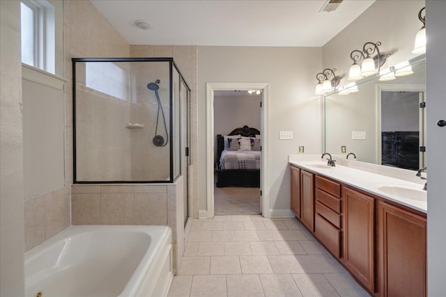 bathroom featuring vanity, tile patterned floors, and separate shower and tub