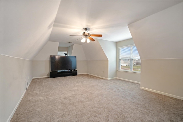 bonus room featuring light colored carpet, ceiling fan, and vaulted ceiling