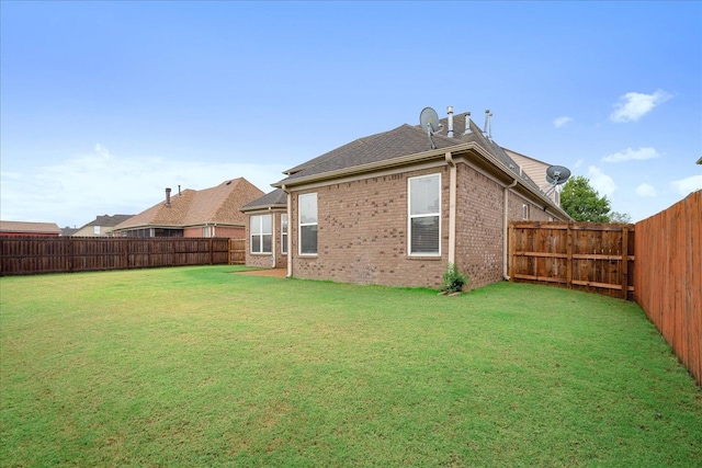 rear view of property with a lawn