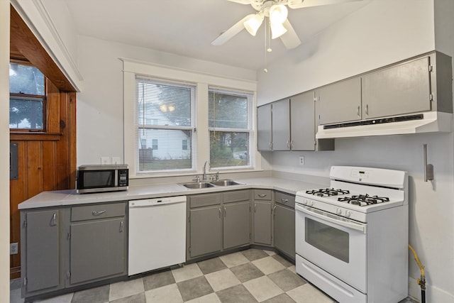 kitchen featuring white appliances, ceiling fan, sink, and gray cabinets