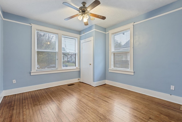 unfurnished room with hardwood / wood-style flooring and ceiling fan