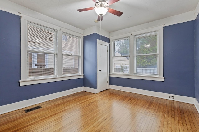 spare room with hardwood / wood-style floors and ceiling fan