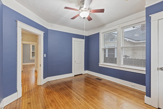 spare room with hardwood / wood-style floors and ceiling fan