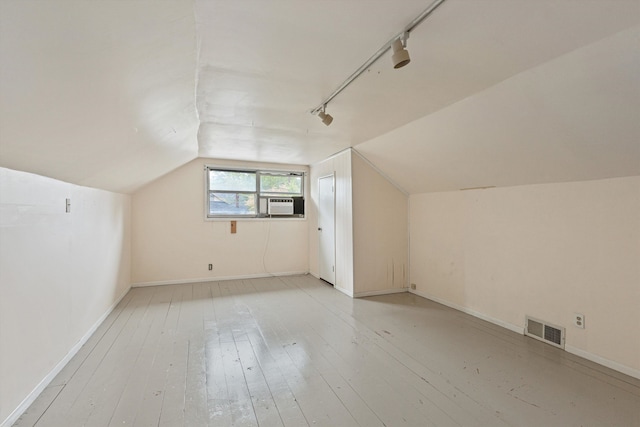 bonus room featuring light hardwood / wood-style floors, cooling unit, and vaulted ceiling