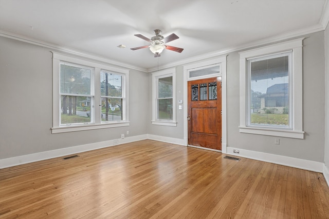 interior space with light hardwood / wood-style floors, ceiling fan, and crown molding