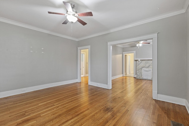 spare room with wood-type flooring, ceiling fan, and crown molding