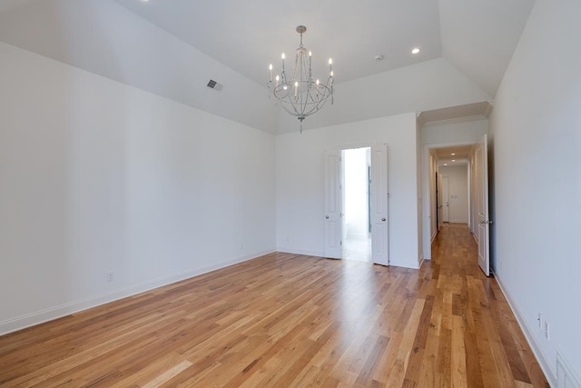 unfurnished room featuring a chandelier, lofted ceiling, and light hardwood / wood-style floors