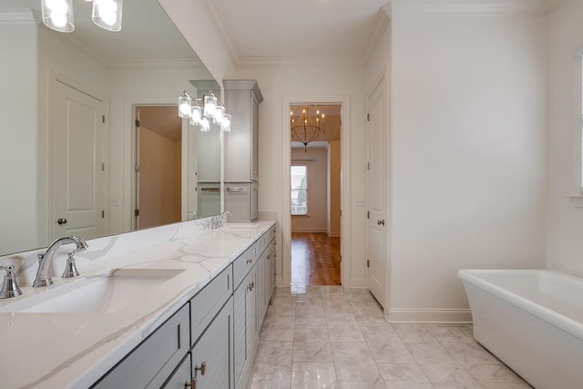 bathroom featuring a washtub, vanity, an inviting chandelier, and crown molding