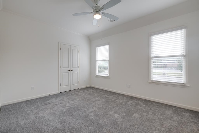 spare room featuring carpet flooring, ceiling fan, and lofted ceiling