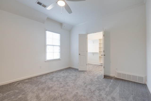 unfurnished room with carpet flooring, ceiling fan, and ornamental molding