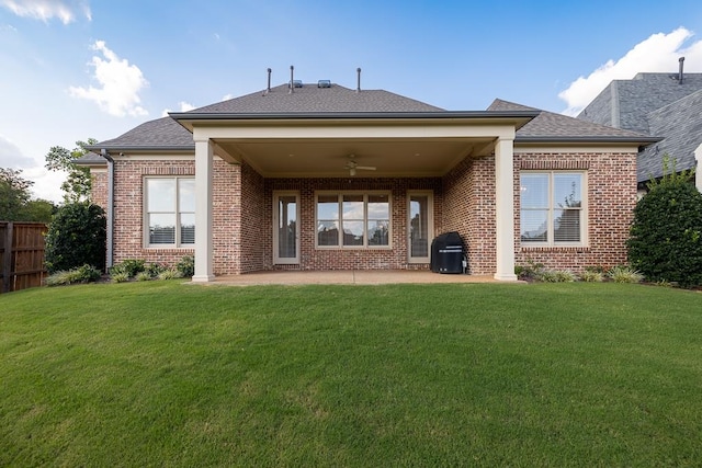 back of house with ceiling fan, a yard, and a patio