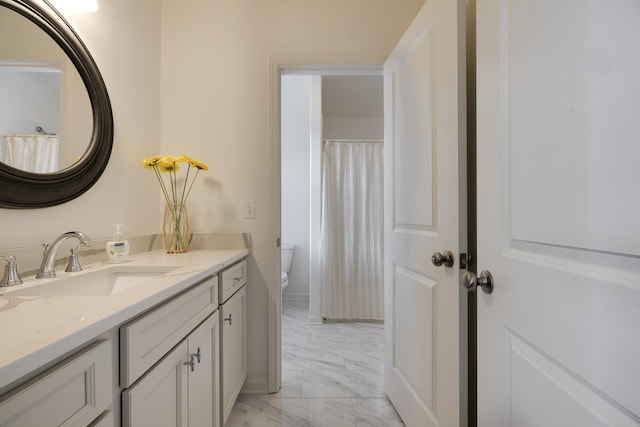 bathroom with vanity and toilet