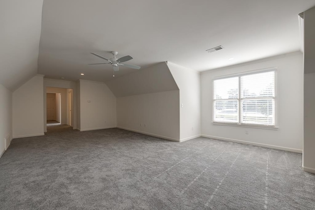 additional living space featuring ceiling fan, light colored carpet, and lofted ceiling