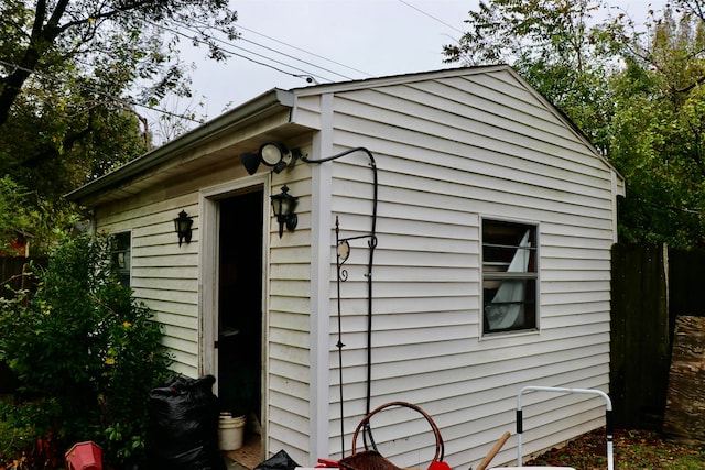 view of outbuilding with fence