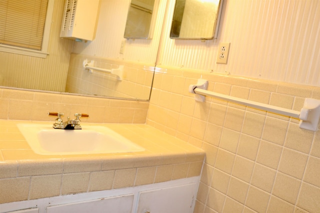 bathroom featuring tile walls and vanity