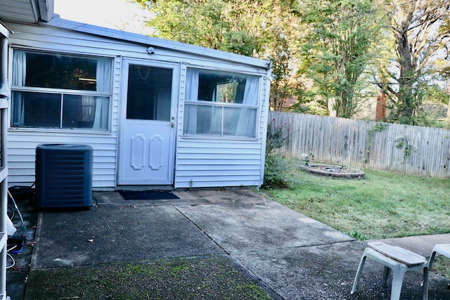 view of outdoor structure with cooling unit and fence