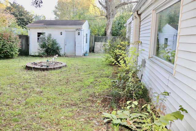 view of yard featuring fence and an outdoor structure