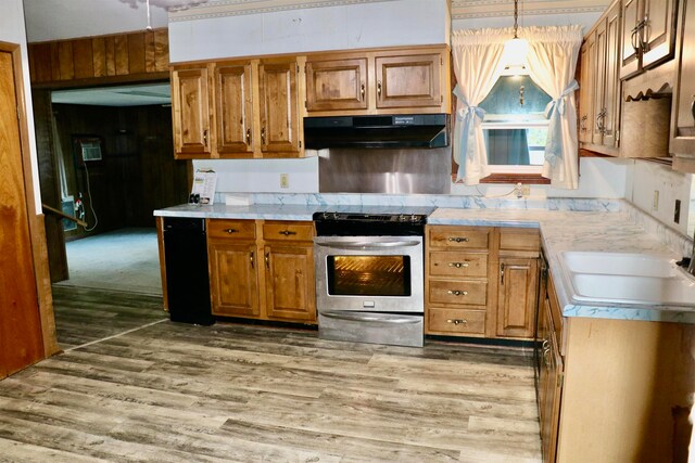 kitchen featuring under cabinet range hood, light countertops, light wood-style floors, and stainless steel range with electric cooktop