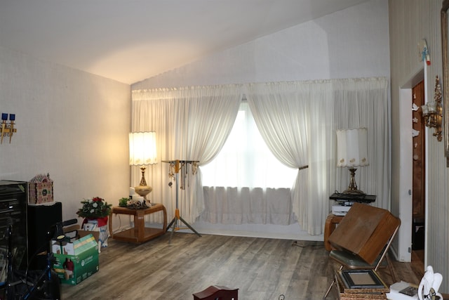 sitting room with lofted ceiling and wood finished floors