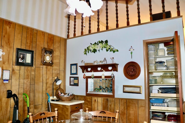 dining room with wainscoting and wooden walls