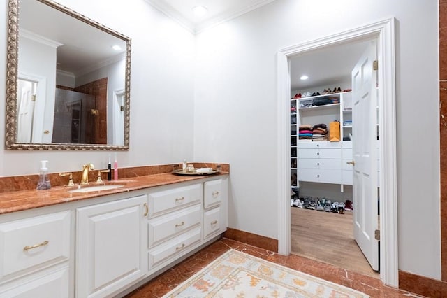 bathroom with vanity, wood-type flooring, a shower with door, and crown molding