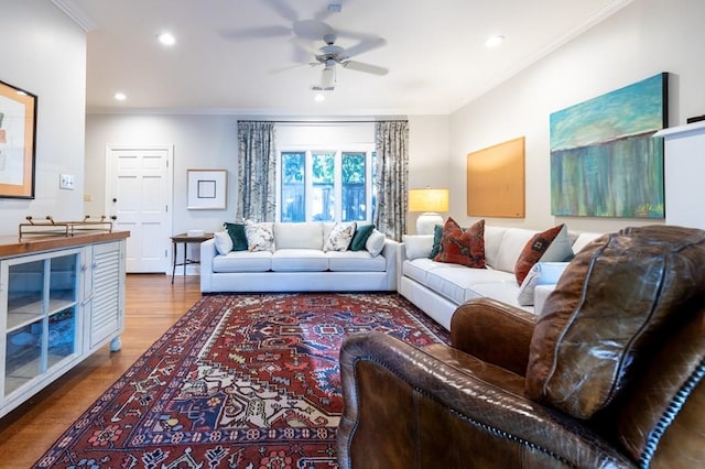 living room with ceiling fan, wood-type flooring, and crown molding