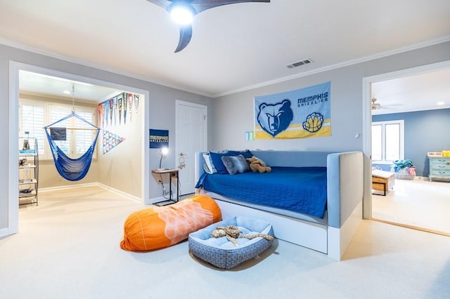 carpeted bedroom featuring ornamental molding and ceiling fan