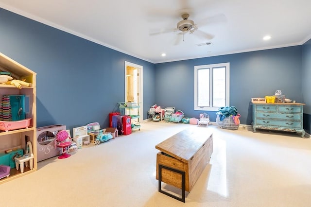 playroom with carpet flooring, ceiling fan, and crown molding