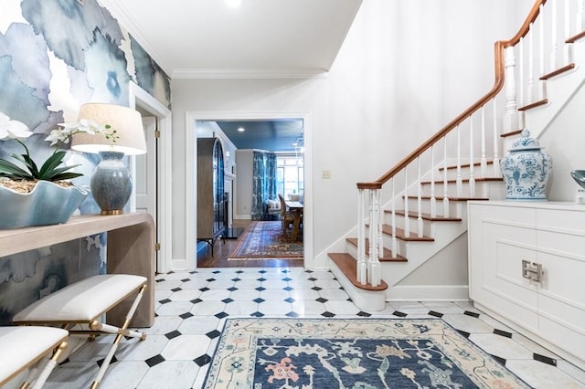 foyer with light hardwood / wood-style flooring and ornamental molding