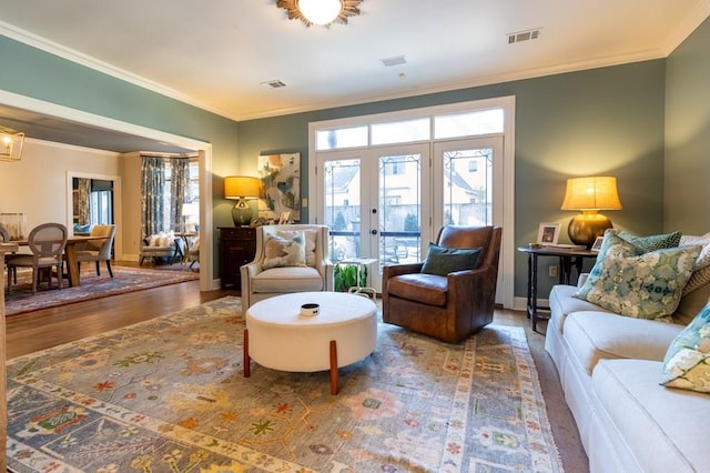 living room featuring french doors, dark hardwood / wood-style flooring, and ornamental molding