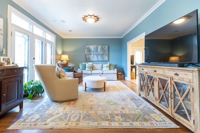 living room featuring french doors, light hardwood / wood-style flooring, and crown molding