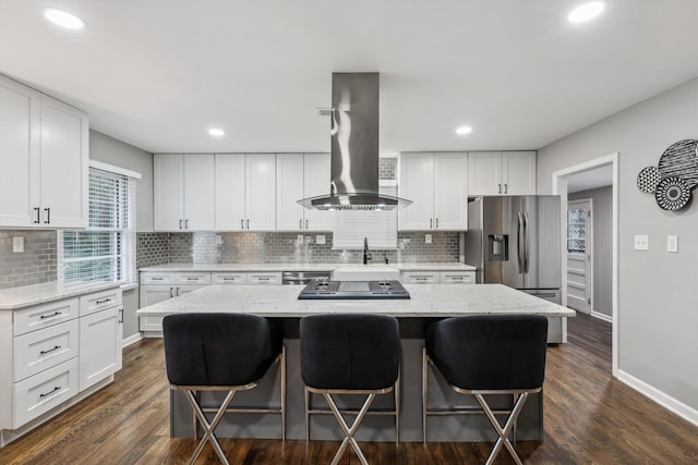 kitchen with dark hardwood / wood-style floors, a center island, white cabinets, and island range hood