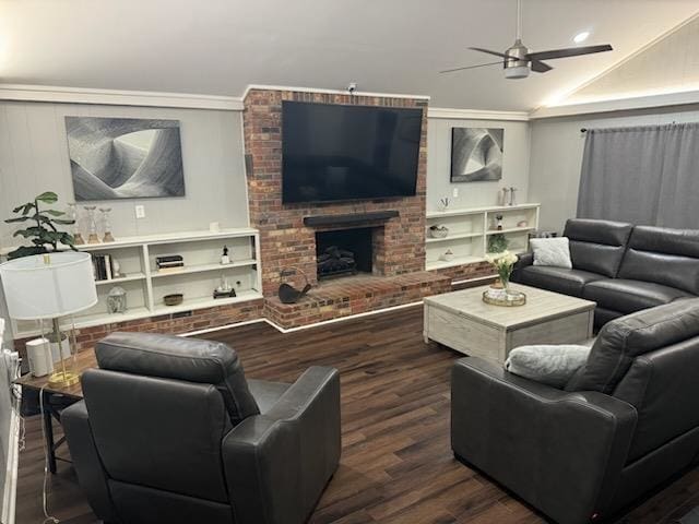 living room featuring ornamental molding, a brick fireplace, lofted ceiling, ceiling fan, and dark hardwood / wood-style floors