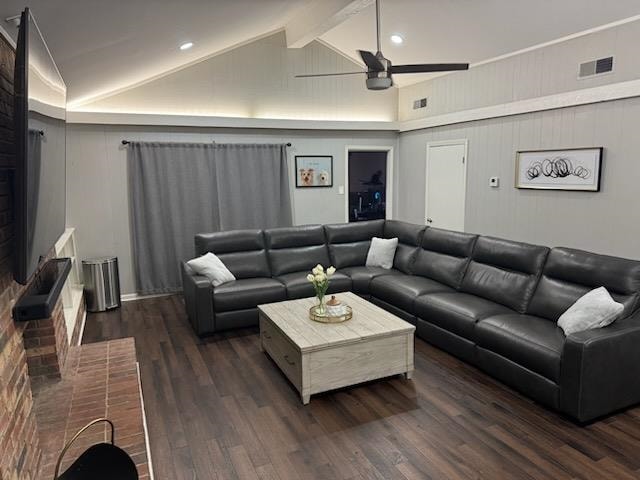 living room featuring beam ceiling, ceiling fan, dark wood-type flooring, and high vaulted ceiling