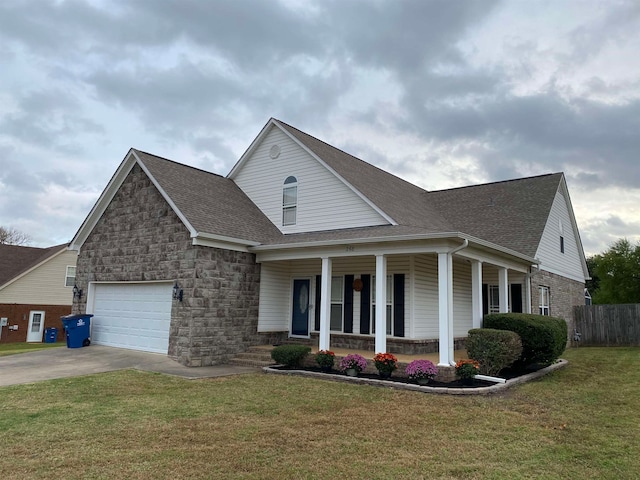 view of front of house with a porch, a front lawn, and a garage