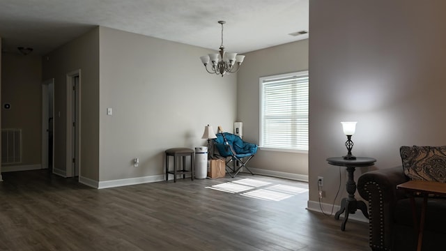 interior space featuring baseboards, visible vents, a chandelier, and dark wood-style flooring