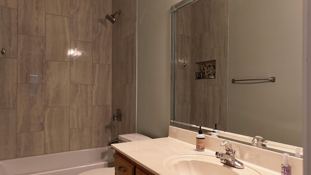 bathroom featuring washtub / shower combination, vanity, and toilet